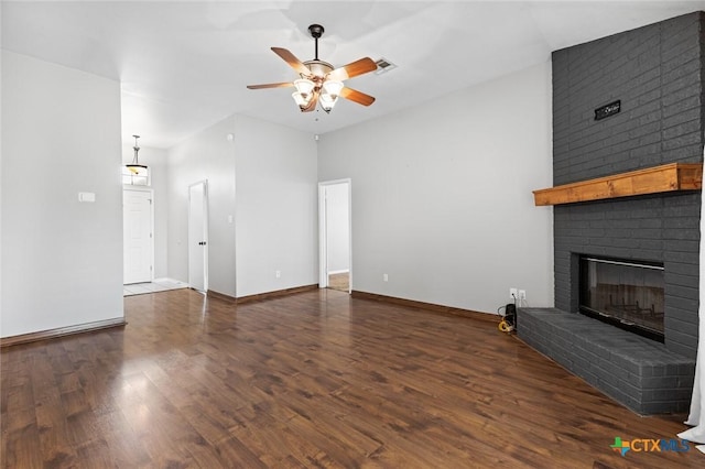 unfurnished living room featuring a fireplace, dark hardwood / wood-style floors, and ceiling fan