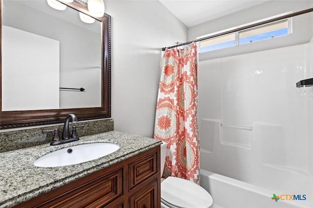 full bathroom featuring shower / bath combination with curtain, vanity, and toilet