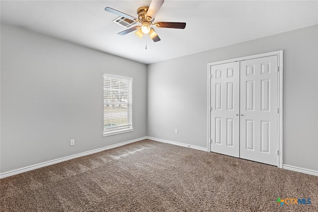 unfurnished bedroom with carpet, a closet, and ceiling fan