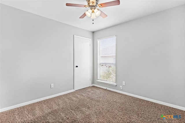 empty room with ceiling fan and carpet floors