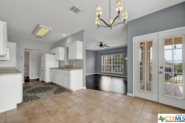 kitchen with white cabinetry, light wood-type flooring, and a healthy amount of sunlight