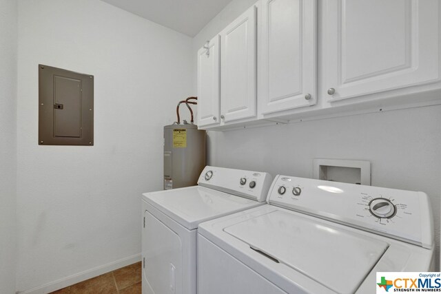 washroom with electric panel, water heater, cabinets, tile patterned flooring, and washing machine and dryer