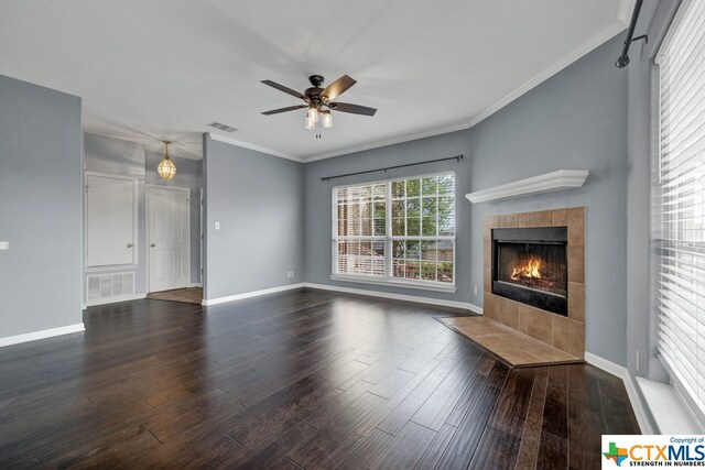 unfurnished living room featuring ornamental molding, dark hardwood / wood-style floors, and a fireplace