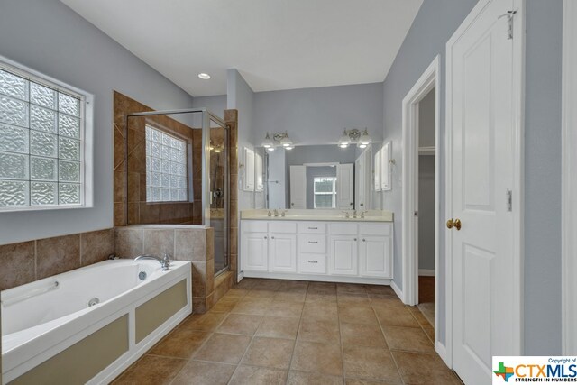 bathroom with vanity, tile patterned floors, and plus walk in shower