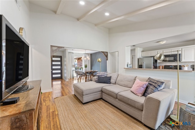 5004 Powder River Rd, Austin, TX 78759 - living area with a chandelier, beamed ceiling, baseboards, and wood finished floors
