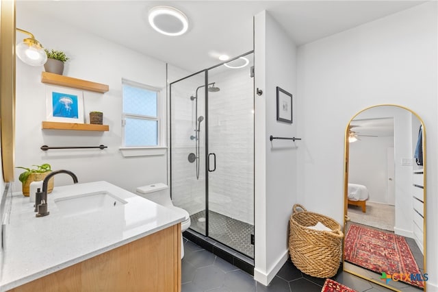 5004 Powder River Rd, Austin, TX 78759 - bathroom featuring vanity, a ceiling fan, a stall shower, ensuite bathroom, and tile patterned floors