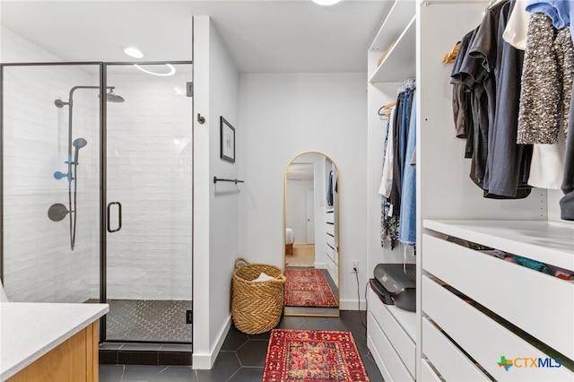 5004 Powder River Rd, Austin, TX 78759 - walk in closet with dark tile patterned floors and arched walkways