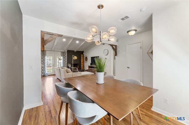 5004 Powder River Rd, Austin, TX 78759 - dining space featuring light wood-style flooring, vaulted ceiling with beams, baseboards, and visible vents