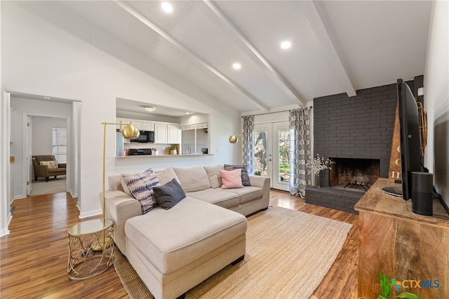 5004 Powder River Rd, Austin, TX 78759 - living room featuring wood finished floors, beamed ceiling, baseboards, recessed lighting, and a brick fireplace