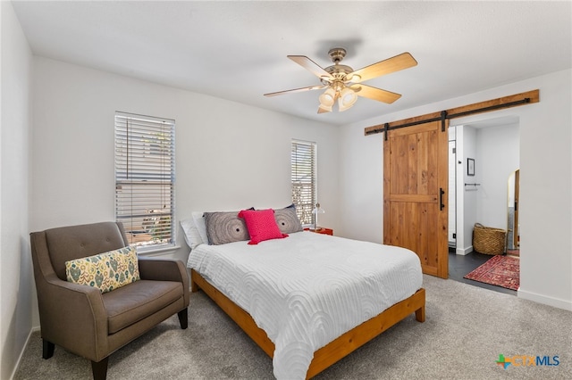 5004 Powder River Rd, Austin, TX 78759 - bedroom featuring a barn door, baseboards, carpet floors, and ceiling fan