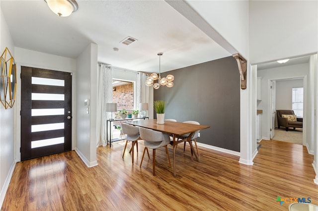 5004 Powder River Rd, Austin, TX 78759 - dining space with visible vents, baseboards, a notable chandelier, and light wood finished floors