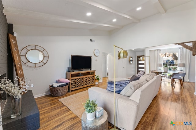 5004 Powder River Rd, Austin, TX 78759 - living room with visible vents, wood finished floors, baseboards, a chandelier, and vaulted ceiling with beams