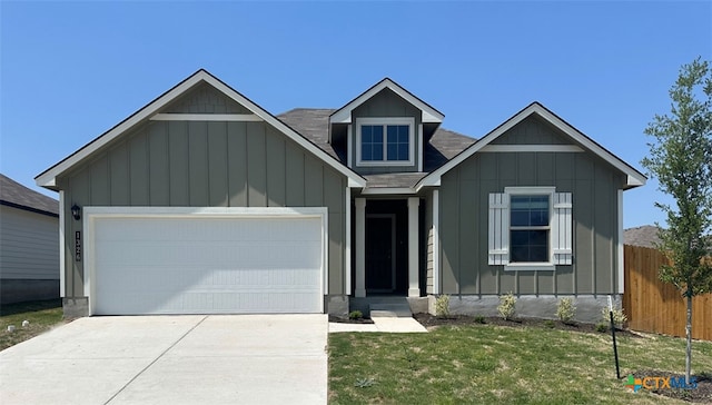 1326 Merritt St, Temple, TX 76579 - view of front facade with a front lawn, driveway, fence, a garage, and board and batten siding