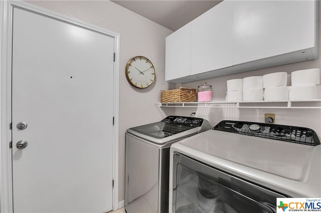 laundry area featuring cabinets and independent washer and dryer