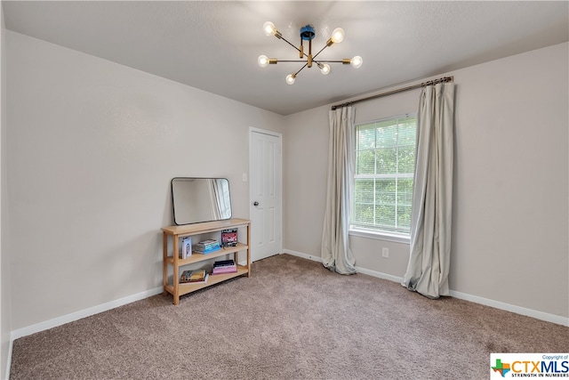 interior space featuring a chandelier and carpet