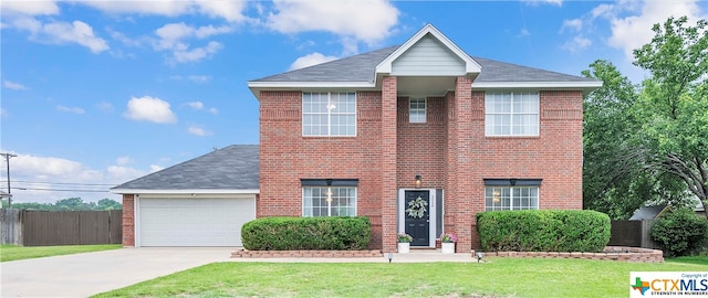 view of front facade with a garage and a front yard