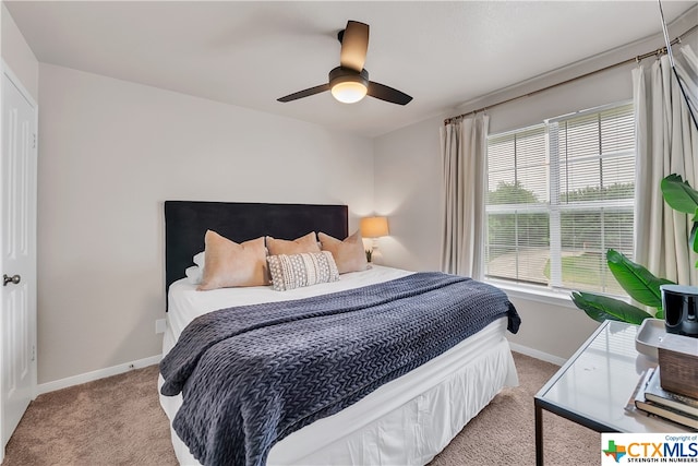 bedroom featuring light carpet and ceiling fan