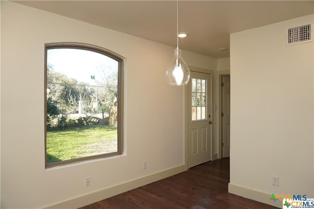 1017/1019 Haynes St Unit 7, San Marcos, TX 78666 - unfurnished dining area featuring baseboards, dark wood-style floors, and recessed lighting