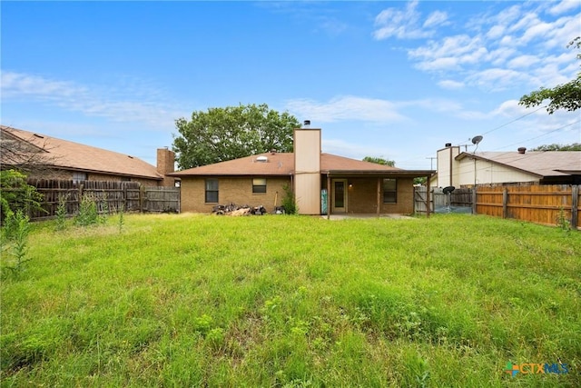 312 Saddle Dr, Copperas Cove, TX 76522 - back of house featuring a fenced backyard, a chimney, a patio, and brick siding