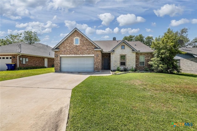 view of front of property featuring a garage, brick siding, a front lawn, and concrete driveway