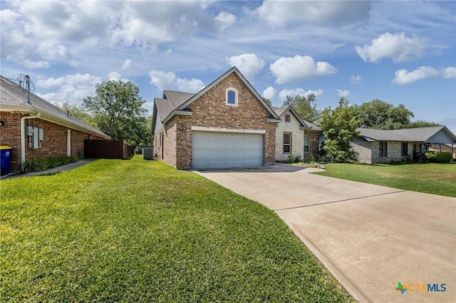 view of front facade featuring fence, a front lawn, concrete driveway, and brick siding