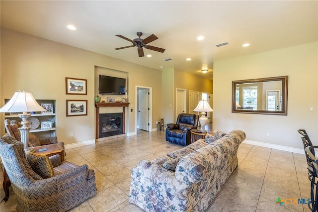 living room with recessed lighting, ceiling fan, a glass covered fireplace, visible vents, and tile patterned flooring