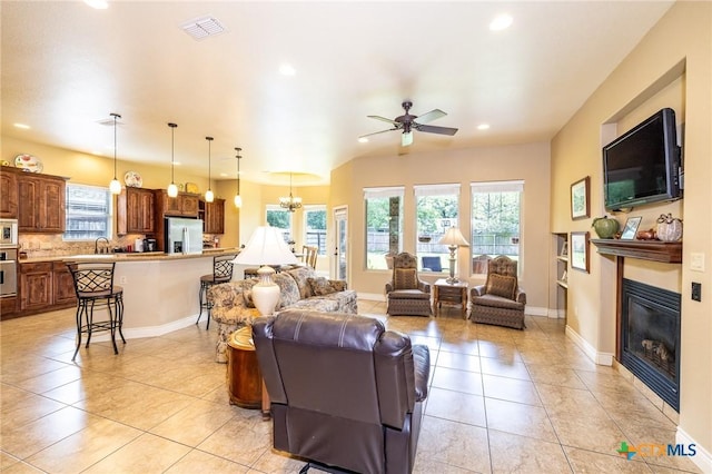 living room featuring visible vents, light tile patterned flooring, and plenty of natural light