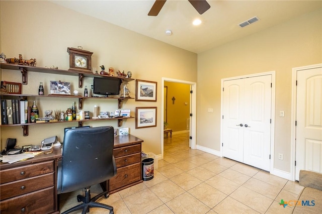 office space with baseboards, visible vents, light tile patterned floors, and ceiling fan