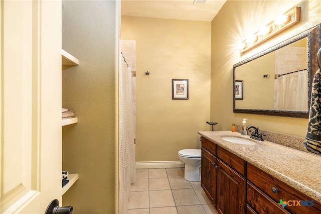 full bath with toilet, tile patterned flooring, vanity, and baseboards