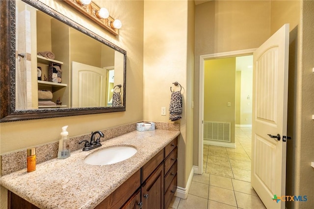 bathroom with tile patterned floors, visible vents, baseboards, and vanity
