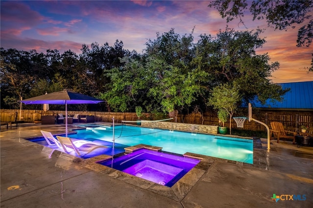 view of pool with a patio, a pool with connected hot tub, and a fenced backyard