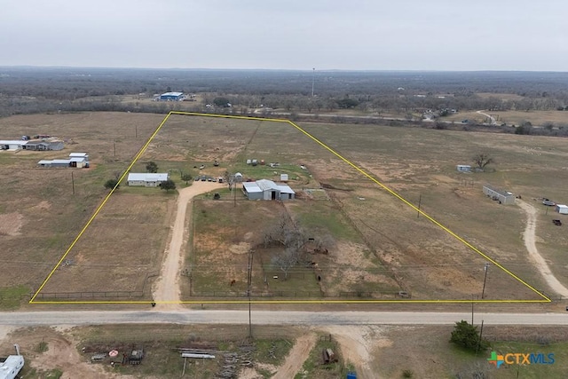 birds eye view of property with a rural view