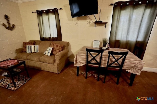 living area featuring concrete block wall