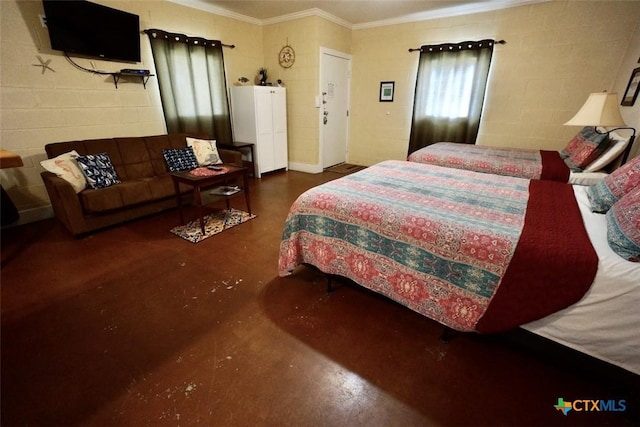 bedroom featuring concrete block wall, concrete flooring, and ornamental molding