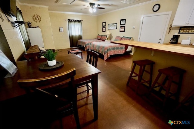 bedroom with crown molding, concrete block wall, and visible vents