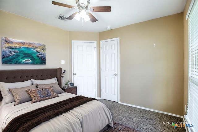 bedroom with visible vents, carpet flooring, baseboards, and ceiling fan
