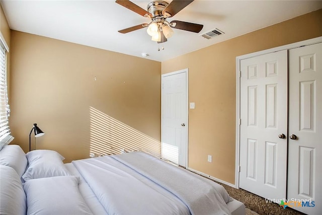 bedroom with a closet, carpet flooring, baseboards, and a ceiling fan