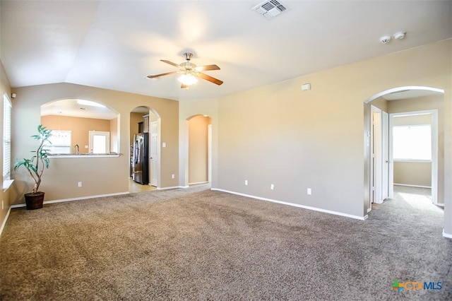 unfurnished room featuring ceiling fan, baseboards, visible vents, and carpet