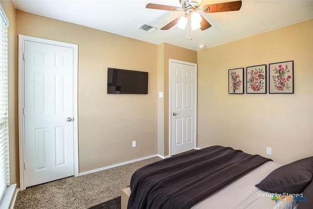 bedroom with visible vents, carpet flooring, baseboards, and a ceiling fan