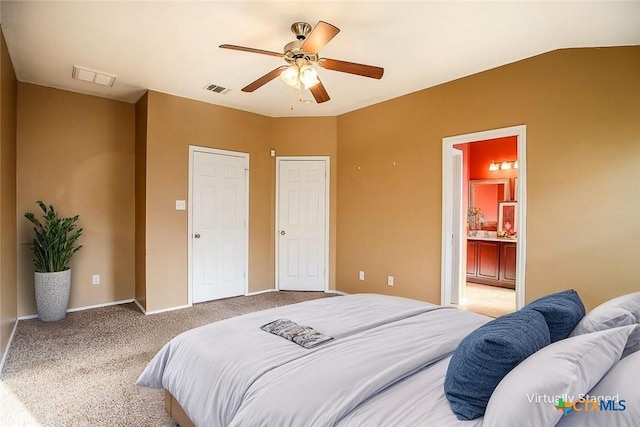 carpeted bedroom with baseboards, ensuite bath, visible vents, and ceiling fan