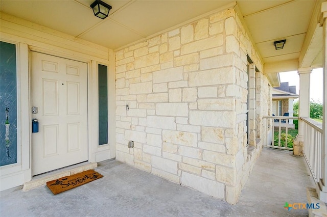 view of exterior entry featuring stone siding