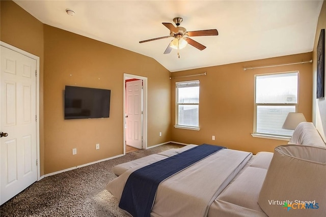 bedroom with baseboards, vaulted ceiling, carpet flooring, and a ceiling fan