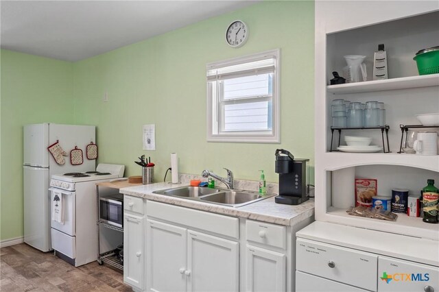 505 N 7th St, Temple, TX 76501 - kitchen with white cabinets, electric stove, light countertops, and a sink