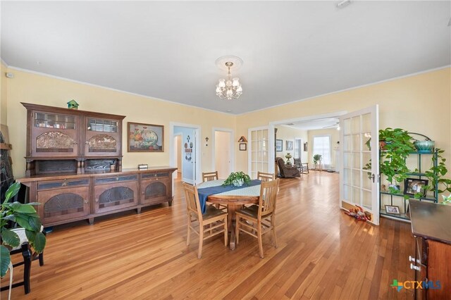 505 N 7th St, Temple, TX 76501 - dining area featuring french doors, light wood finished floors, and an inviting chandelier