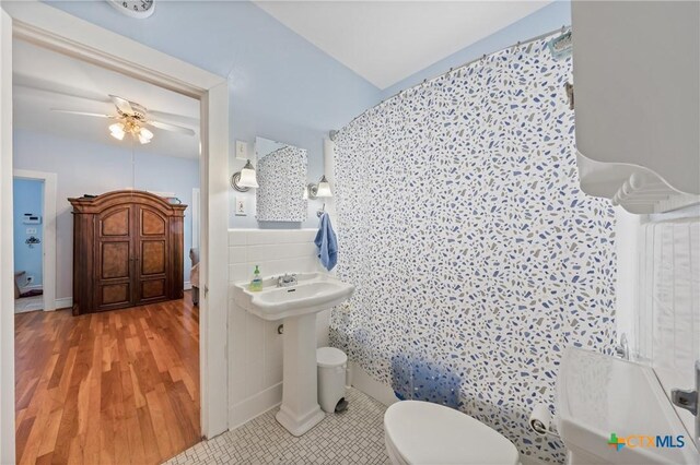 505 N 7th St, Temple, TX 76501 - bathroom with toilet, tile walls, a ceiling fan, and tile patterned flooring