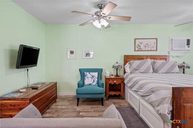 505 N 7th St, Temple, TX 76501 - bedroom with a wall unit AC, wood finished floors, and a ceiling fan