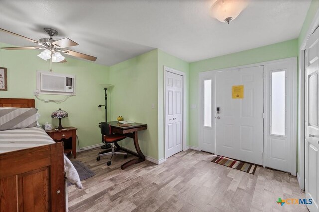 505 N 7th St, Temple, TX 76501 - foyer entrance with light wood finished floors, baseboards, a wall unit AC, and a ceiling fan
