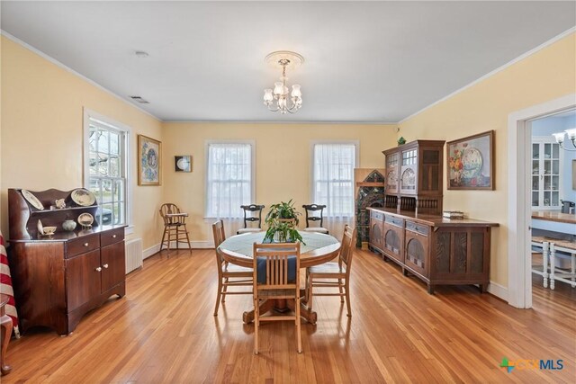 505 N 7th St, Temple, TX 76501 - dining area featuring radiator, ornamental molding, a chandelier, light wood finished floors, and baseboards