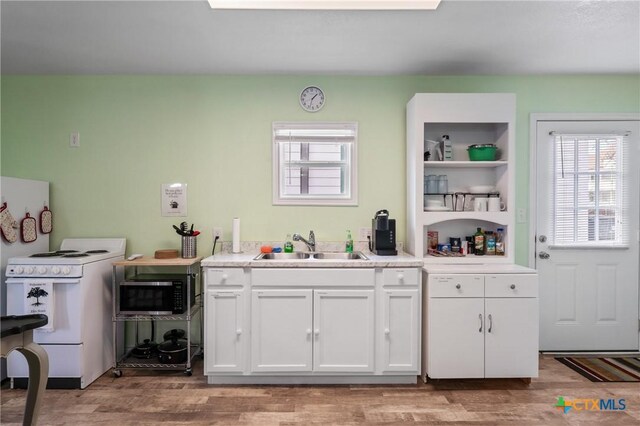 505 N 7th St, Temple, TX 76501 - kitchen featuring a wealth of natural light, white cabinets, white electric range, and a sink