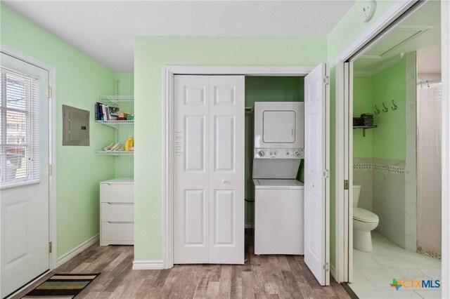 505 N 7th St, Temple, TX 76501 - laundry area featuring electric panel, stacked washer / dryer, laundry area, and wood finished floors